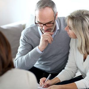 Mid-aged couple working on financial or estate planning